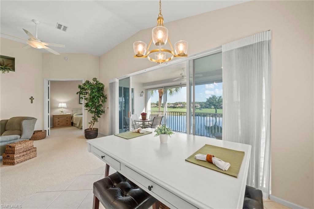 23101 Rosedale Drive, Unit 202 Estero, FL 34135 - Photo 24 of 49 a view of a dining room with furniture a chandelier and a large window