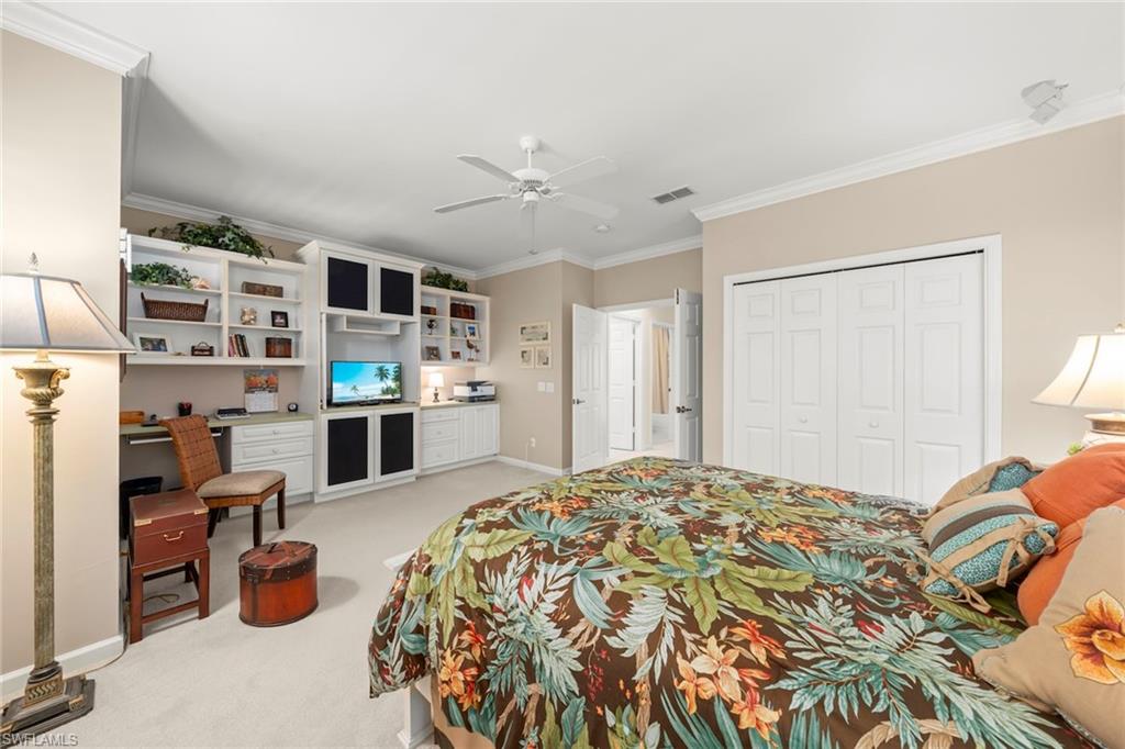 23101 Rosedale Drive, Unit 202 Estero, FL 34135 - Photo 29 of 49 a bedroom with furniture and a chandelier