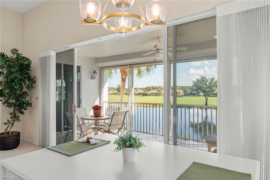 23101 Rosedale Drive, Unit 202 Estero, FL 34135 - Photo 3 of 49 a dining room with furniture wooden floor and a potted plant