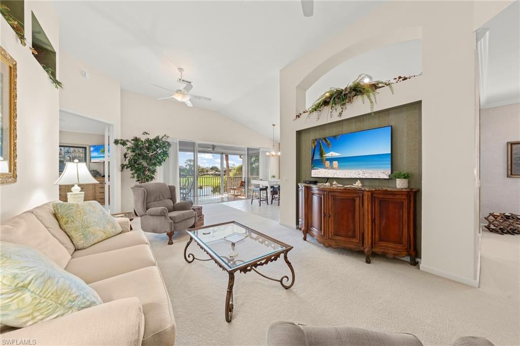 23101 Rosedale Drive, Unit 202 Estero, FL 34135 - Photo 4 of 49 a living room with furniture and a fireplace
