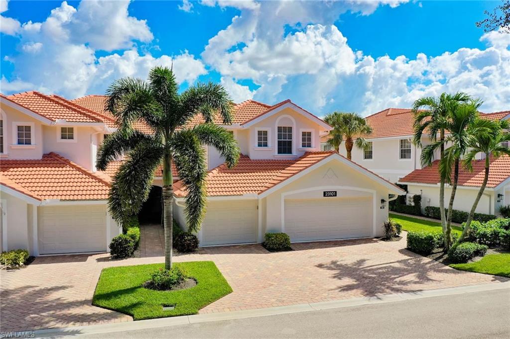 23101 Rosedale Drive, Unit 202 Estero, FL 34135 - Photo 46 of 49 a front view of a house with garden