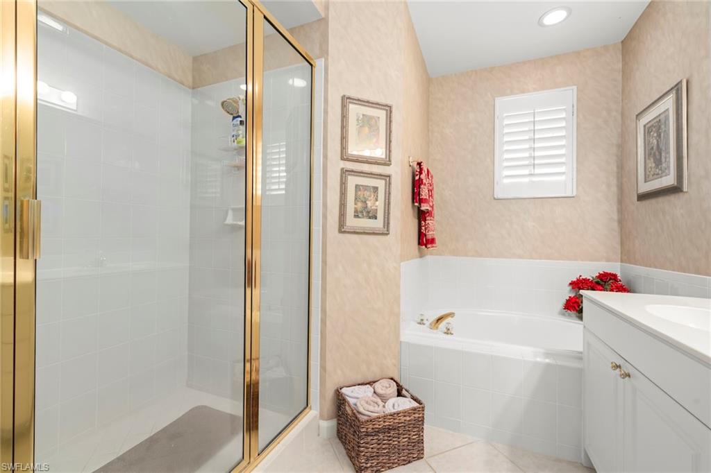 23101 Rosedale Drive, Unit 202 Estero, FL 34135 - Photo 8 of 49 a bathroom with a bathtub a sink and a shower
