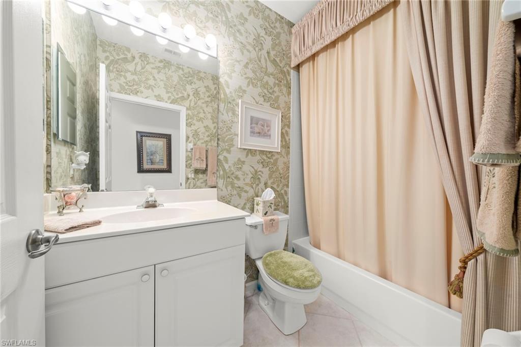 23101 Rosedale Drive, Unit 202 Estero, FL 34135 - Photo 10 of 49 a bathroom with a sink toilet and shower
