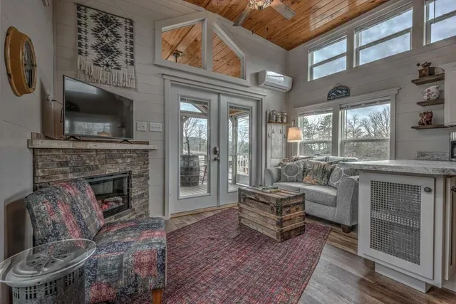 a living room with furniture a flat screen tv and kitchen view