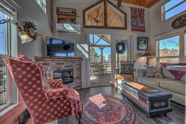 a living room with furniture a flat screen tv and a fireplace