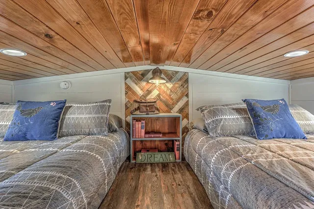 a bed sitting in a bedroom next to a larger window