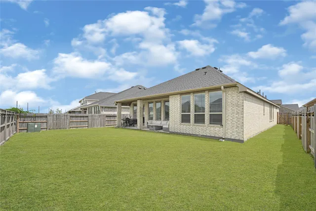 a front view of a house with yard and balcony