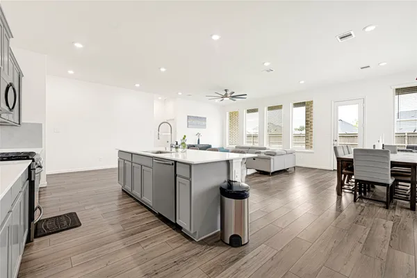 a kitchen with counter top space and windows