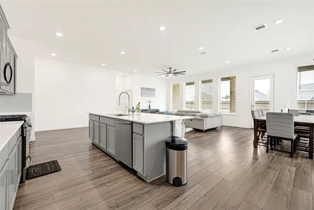 a kitchen with counter top space and windows