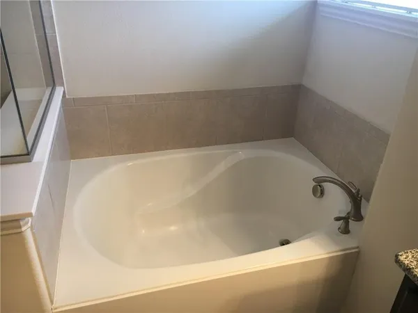 a bathroom with a shower and a bath tub