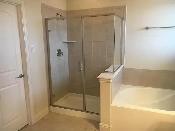 a bathroom with a granite countertop bathtub sink and a mirror