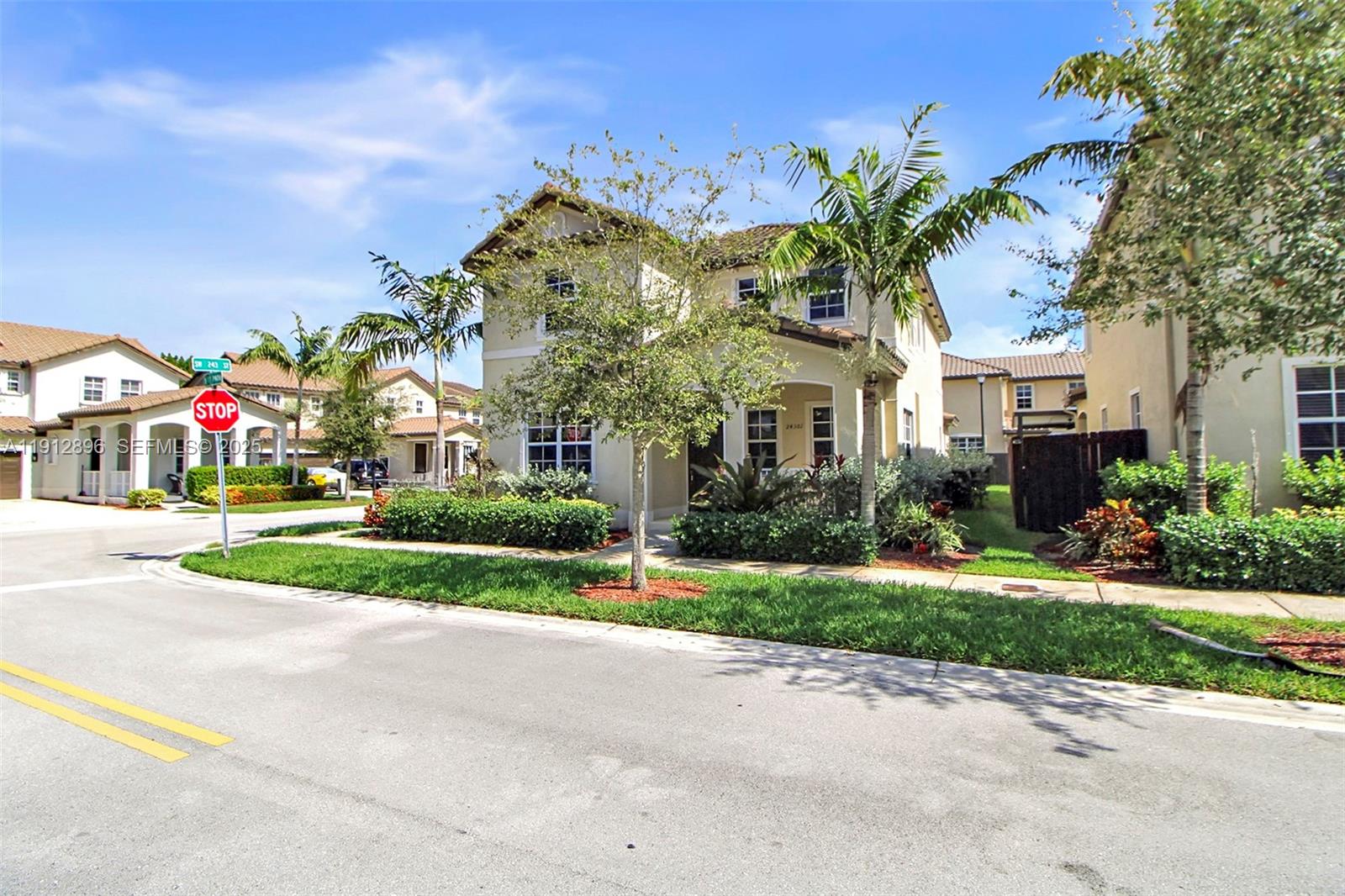 24301 Southwest 117 Path Homestead, FL 33032 - Photo 13 of 50 a view of a white house with a big yard and potted plants