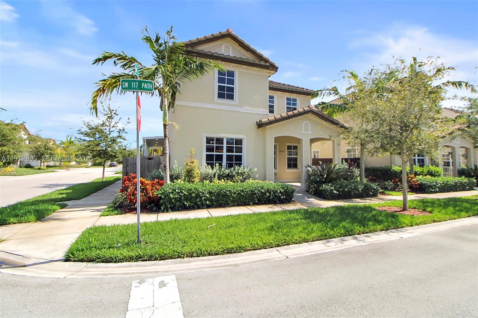 24301 Southwest 117 Path Homestead, FL 33032 - Photo 14 of 50 a front view of a house with a yard and potted plants