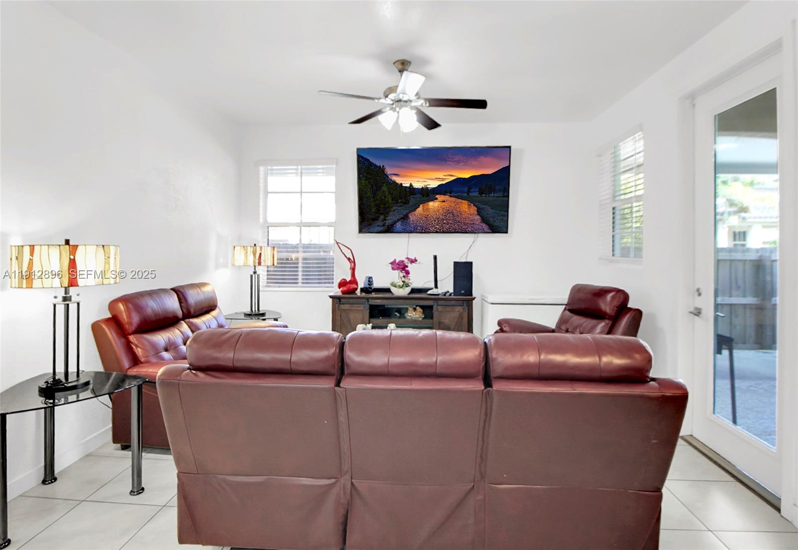 24301 Southwest 117 Path Homestead, FL 33032 - Photo 19 of 50 a living room with furniture and a flat screen tv