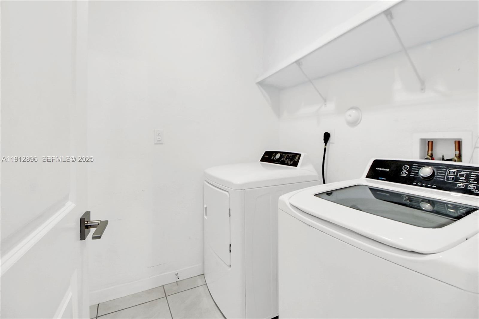 24301 Southwest 117 Path Homestead, FL 33032 - Photo 26 of 50 a view of washer and dryer with bathroom in the background