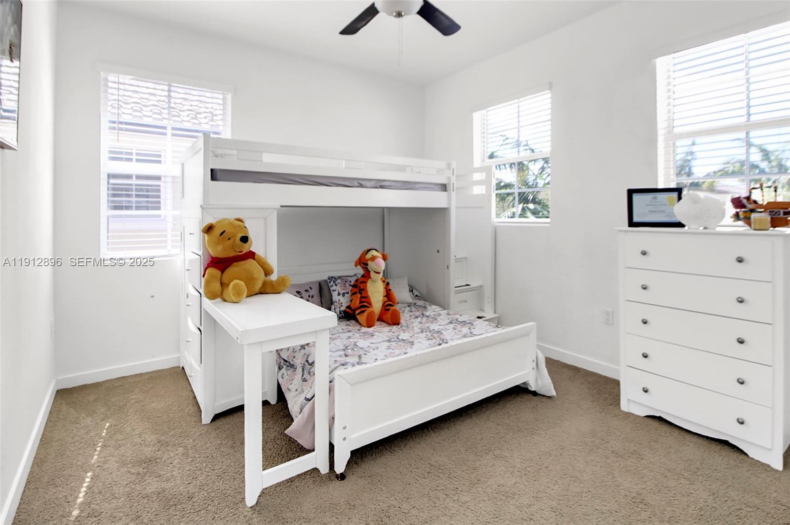 24301 Southwest 117 Path Homestead, FL 33032 - Photo 29 of 50 a bedroom with two beds and a chandelier