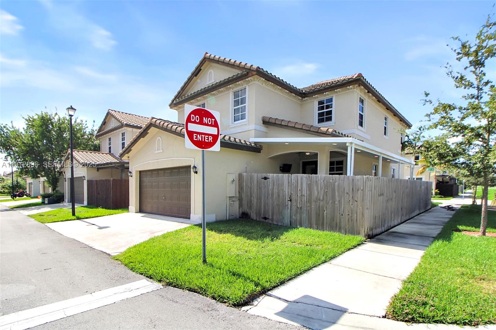 24301 Southwest 117 Path Homestead, FL 33032 - Photo 3 of 50 a front view of a house with a yard and garage