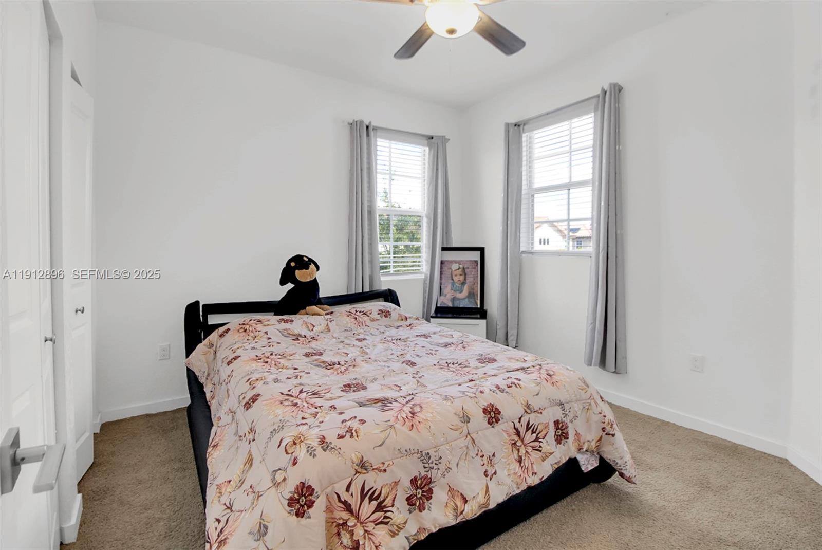 24301 Southwest 117 Path Homestead, FL 33032 - Photo 32 of 50 a bedroom with a bed and window