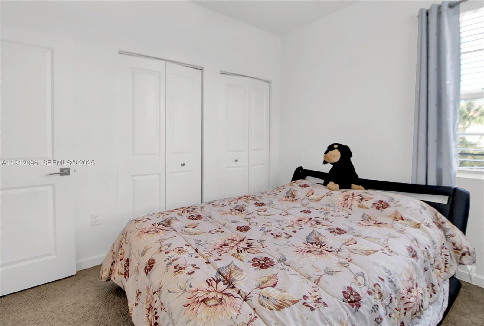 24301 Southwest 117 Path Homestead, FL 33032 - Photo 33 of 50 a bedroom with a bed and a window