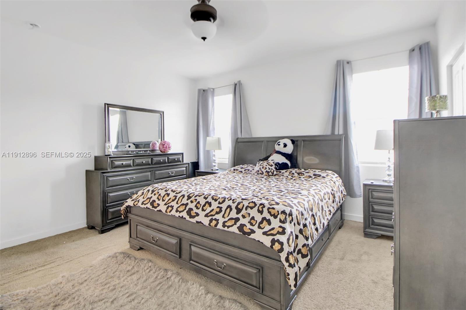 24301 Southwest 117 Path Homestead, FL 33032 - Photo 35 of 50 a bedroom with a bed and dresser with mirror