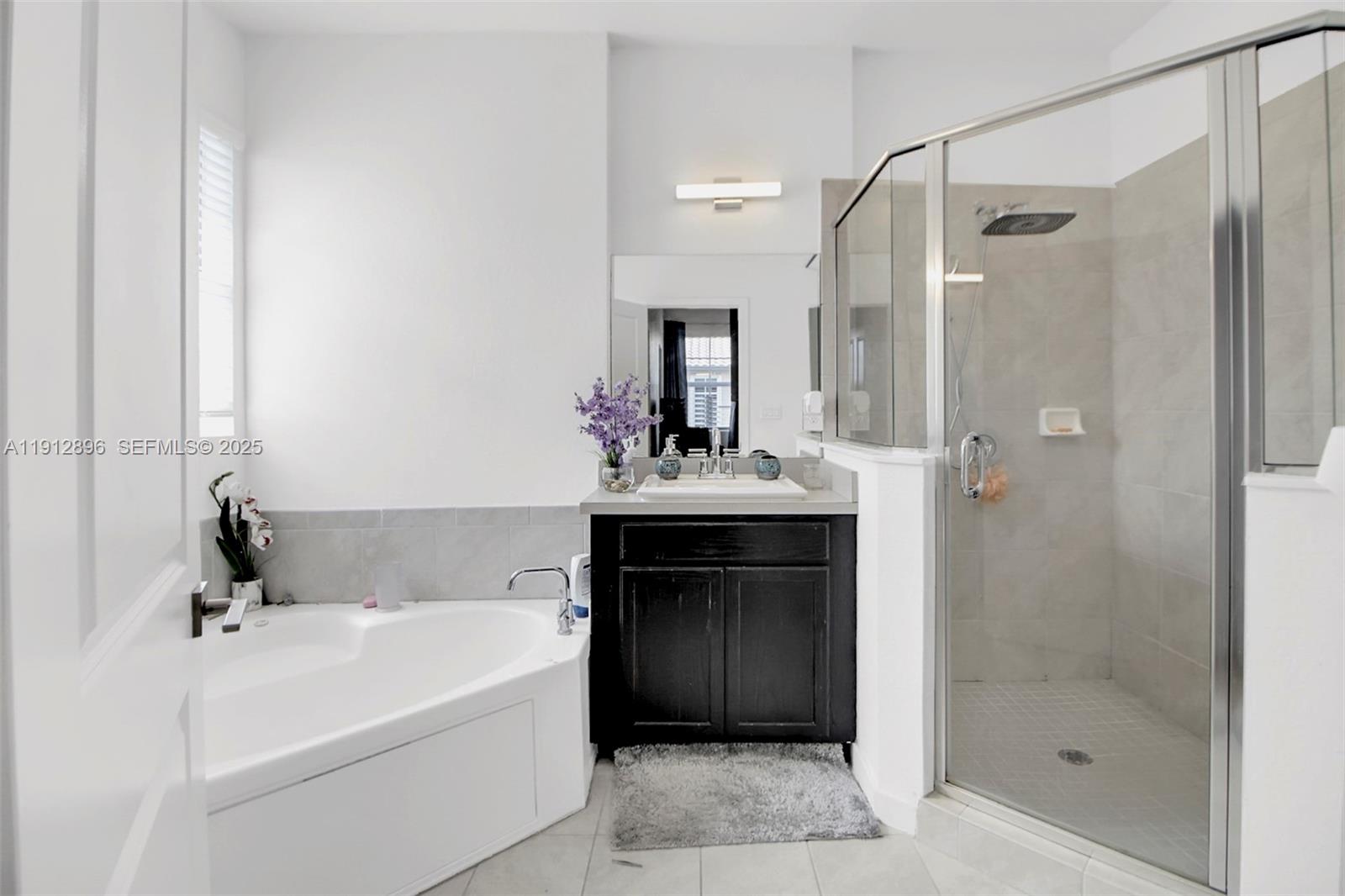 24301 Southwest 117 Path Homestead, FL 33032 - Photo 39 of 50 a bathroom with a bathtub shower sink and mirror