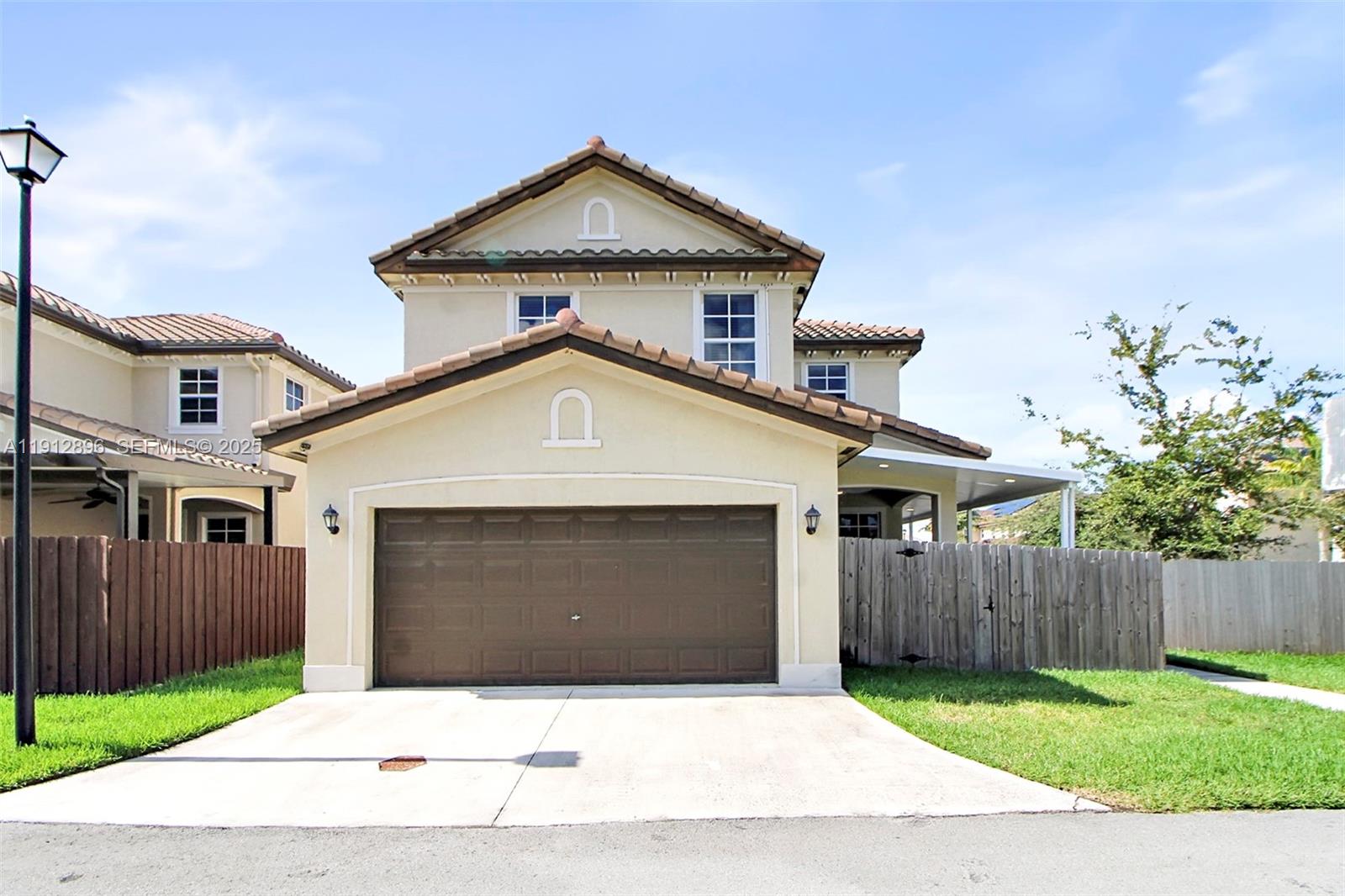 24301 Southwest 117 Path Homestead, FL 33032 - Photo 4 of 50 a front view of a house with a yard and garage