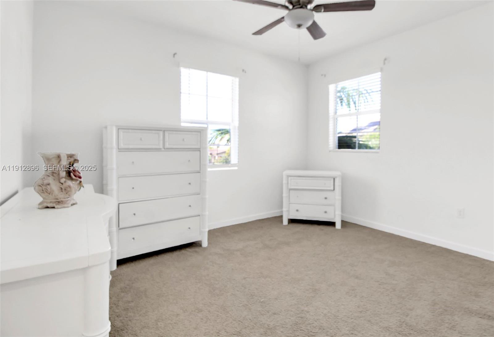 24301 Southwest 117 Path Homestead, FL 33032 - Photo 42 of 50 a view of a bedroom with furniture and a window