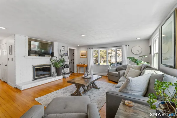 a living room with furniture flat screen tv and a fireplace