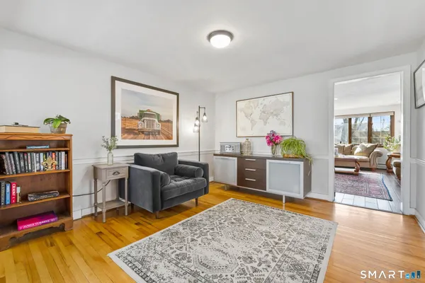 a living room with furniture and a book shelf