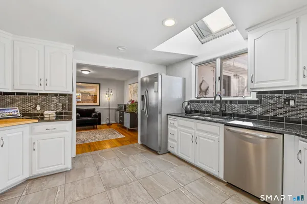a large kitchen with cabinets and stainless steel appliances
