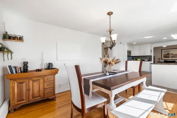 a dining room with furniture and wooden floor