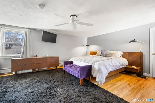 a bedroom with a bed and flat screen tv
