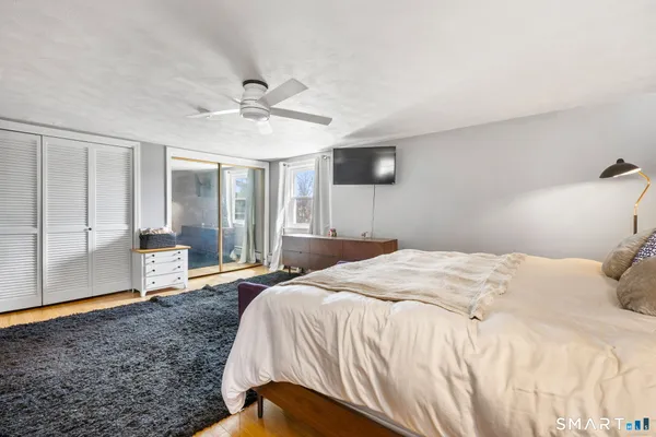 a bedroom with a large bed and a chandelier