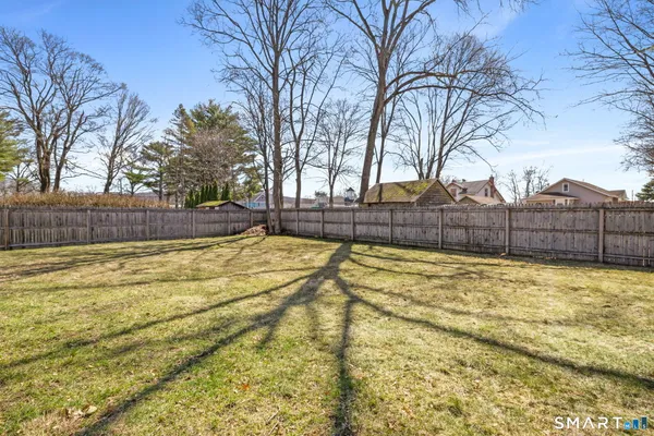 a view of yard with swimming pool and trees