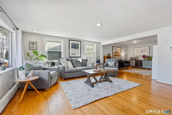 a living room with furniture and a wooden floor