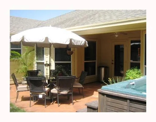 a view of a patio with table and chairs