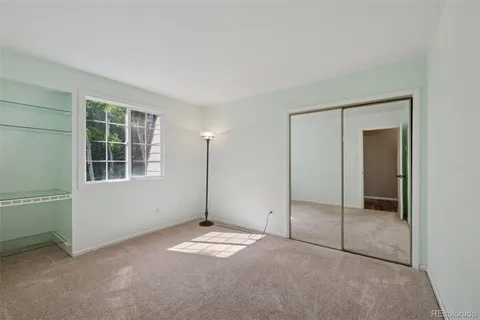 an empty room with windows and closet