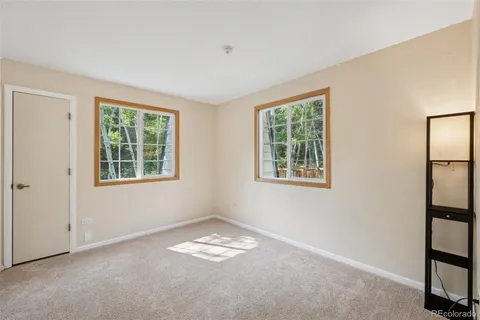 a view of wooden floor and windows in a room