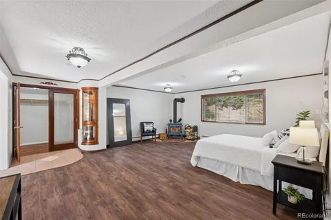 a view of a bedroom with furniture and wooden floor