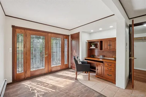 a view of a workspace with furniture and a window