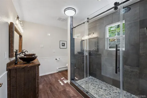 a bathroom with a shower and a mirror