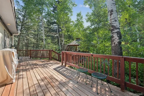 a view of balcony with wooden floor and outdoor seating