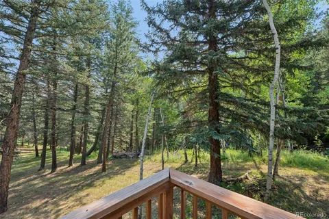 a view of a wooden deck and trees