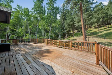 a view of deck with wooden floor and fence