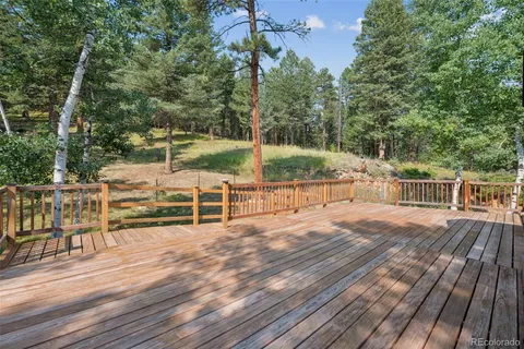 a view of a deck with chairs and wooden floor