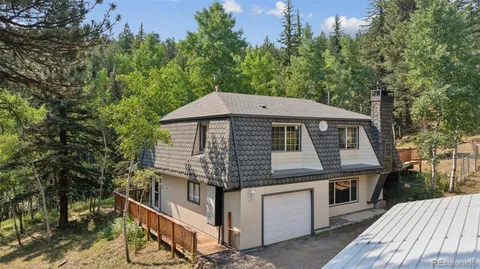 a roof deck with table and chairs under an umbrella