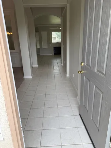a view of a hallway to rooms and stairs