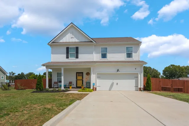 a front view of a house with a garden and yard