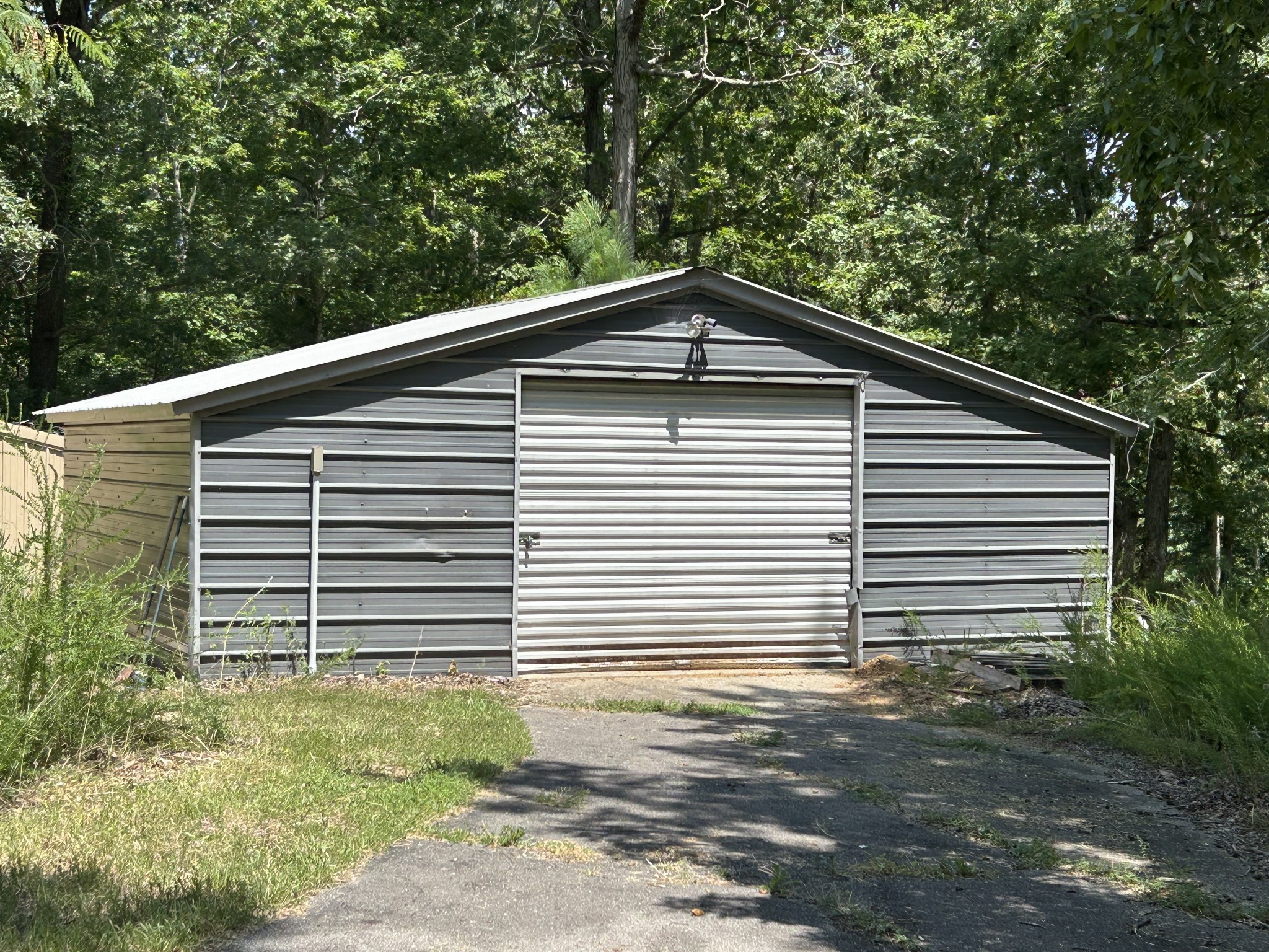 885 Sandys Camp Road Big Sandy, TN 38221 - Photo 19 of 22 a front view of a house with a garage