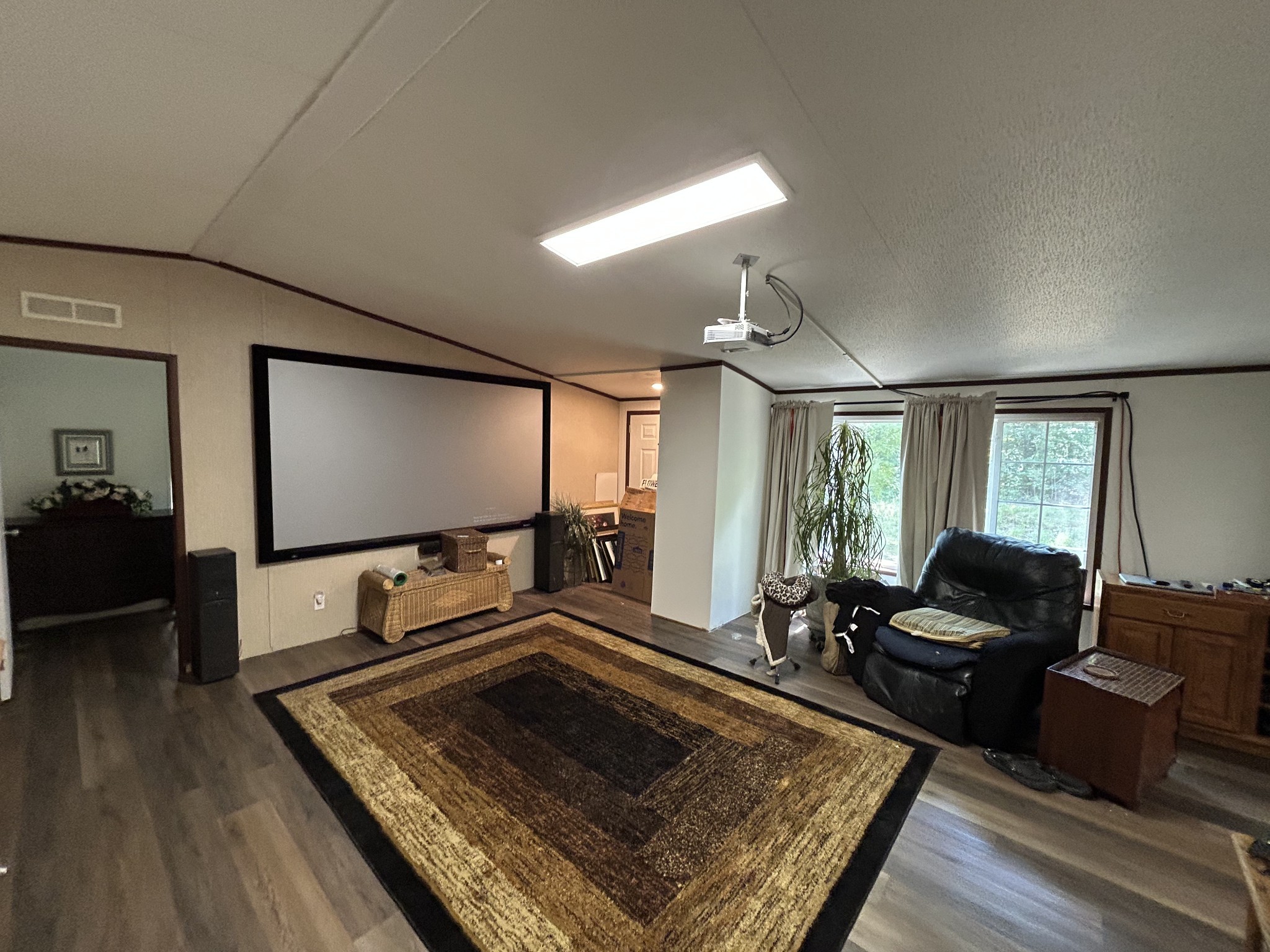 885 Sandys Camp Road Big Sandy, TN 38221 - Photo 8 of 22 a living room with furniture flat screen tv and a large window